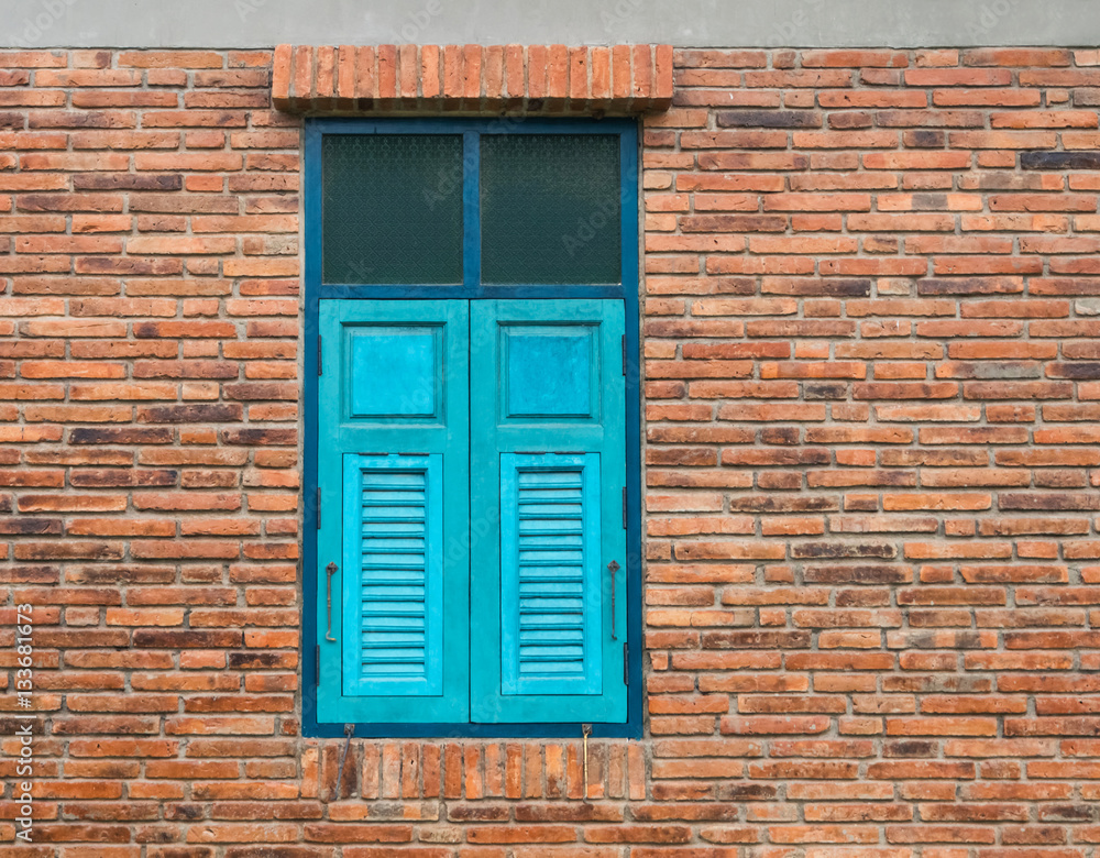 The blue wooden window with a brick wall. The blue wooden window with a brick wall.