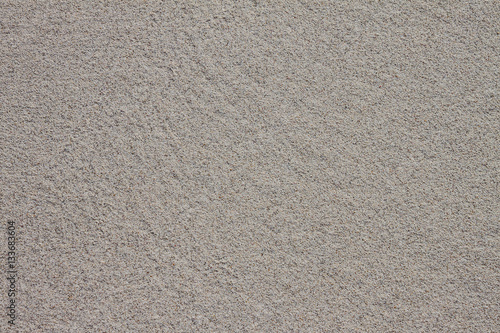 Close-up seamless sand background. Sand texture. Sandy beach for background. Top view. Photos clean, smooth, wet sand closeup. Texture of white sand with a gray tint. Photos sea coast