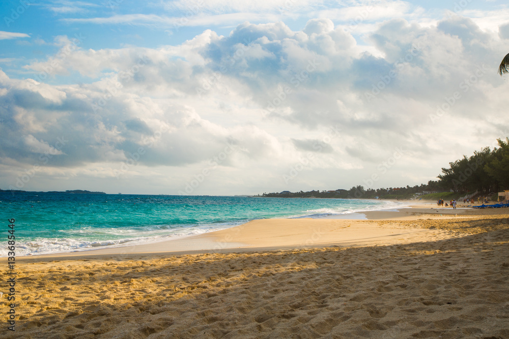 Carribean beach with blue sea horison line and sandy shore