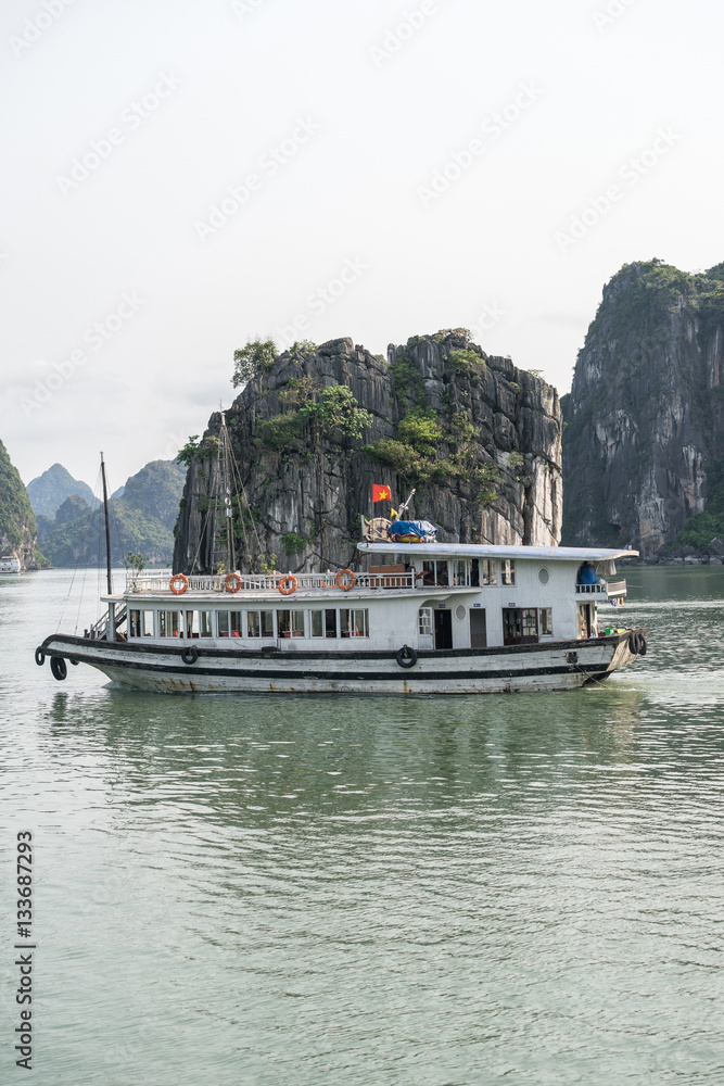 Naklejka premium Beautiful landscape of lagoon in the Ha Long Bay (Descending Dragon Bay) at the Gulf of Tonkin of the South China Sea, Vietnam. Tourist boat in a famous Ha Long Bay.