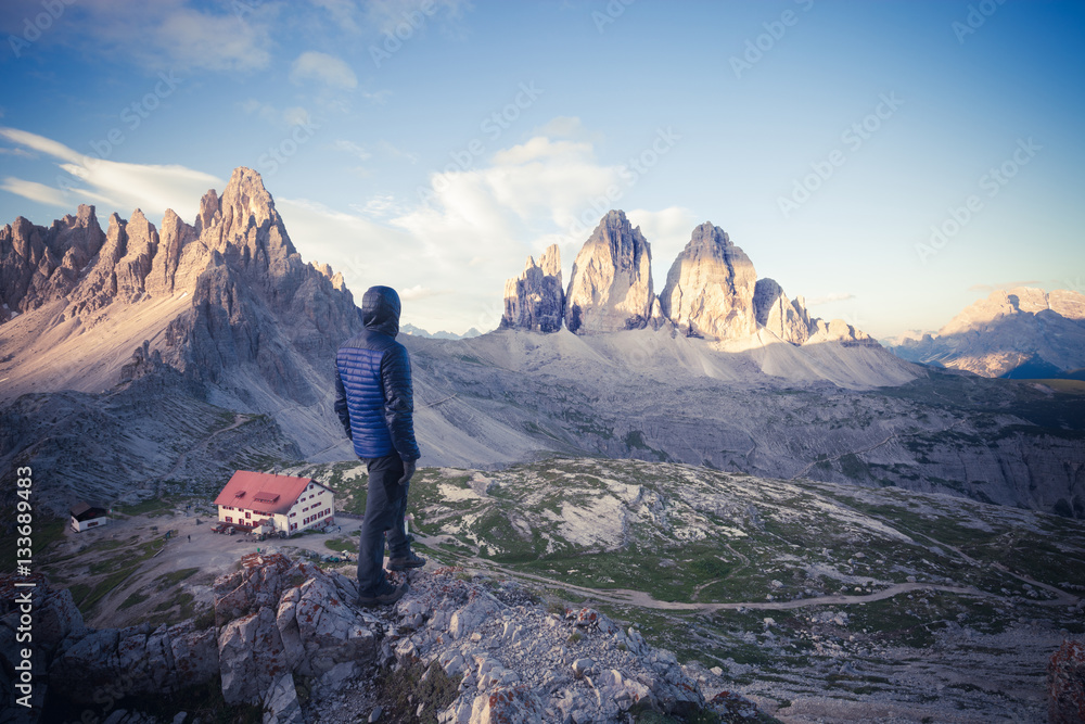 Man on the top of the mountain watching sunrise