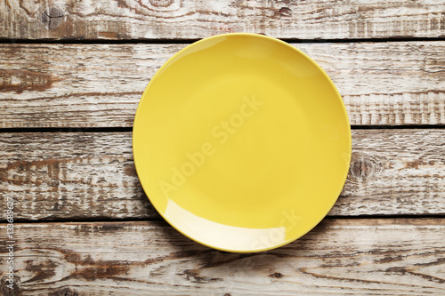 Empty plate on brown wooden table