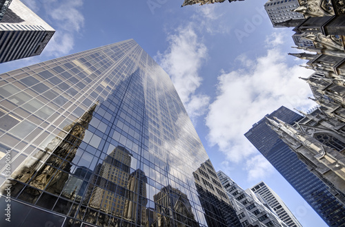 Tall skyscraper in New York city, blue sky in background.