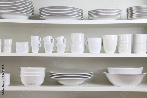 white dishes on a white shelf
 photo