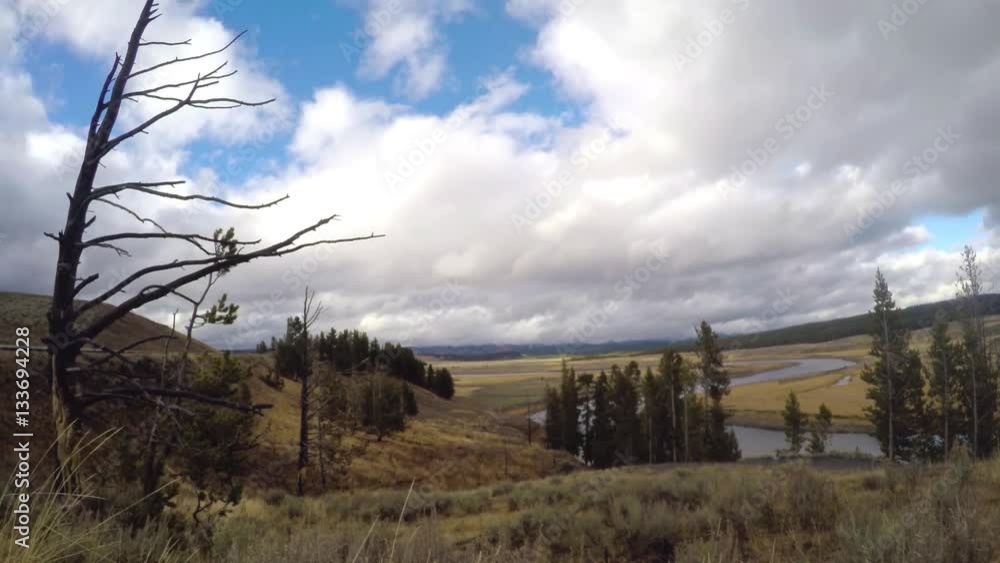 Timelapse of forest, fields and ponds, at a cloudy autumn day, in Yellowstone national park, in Wyoming, United states of America Timelapse of forest, fields and ponds, at a cloudy autumn day, in Yellowstone national park, in Wyoming, United states of America