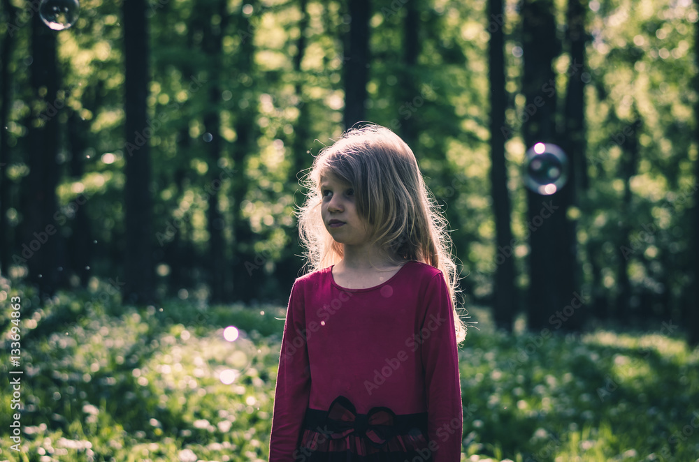 sad girl watching soap bubbles sad girl watching soap bubbles