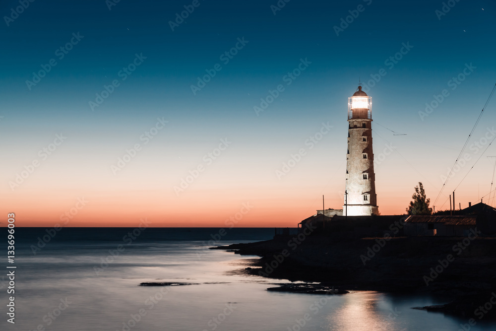lighthouse at sunset in the twilight in clear weather