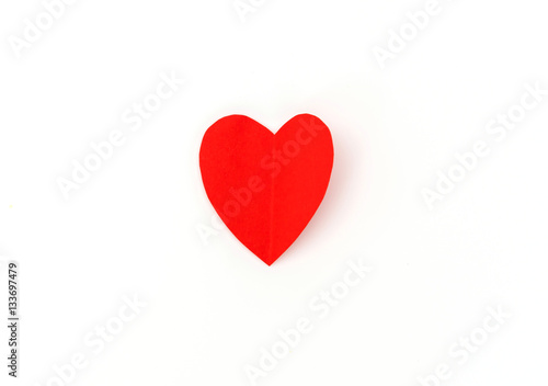 Red paper origami heart on white background .