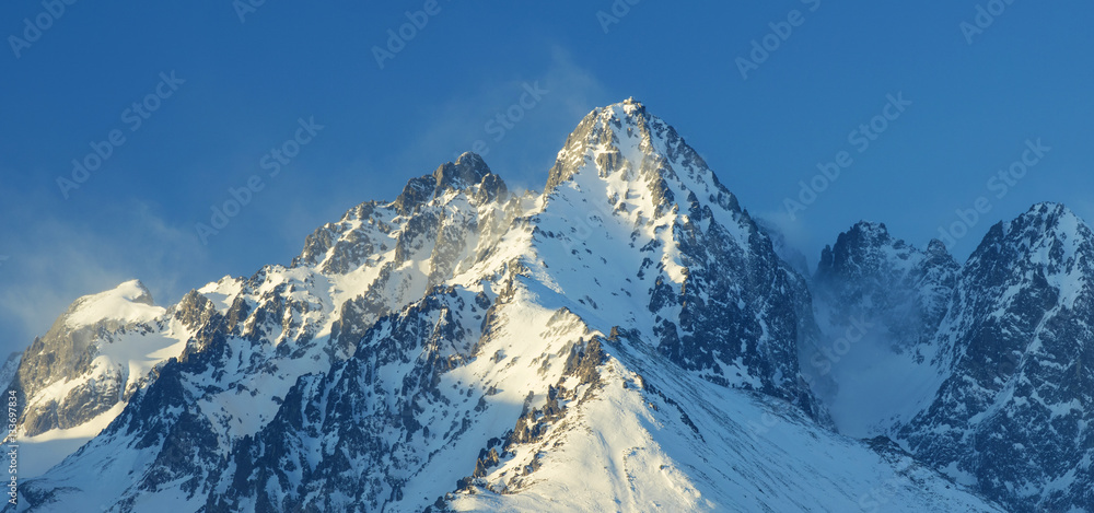 high snowed summits under blue sky