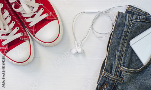 Red sneakers with blue jeans, a smartphone in your pocket, a top