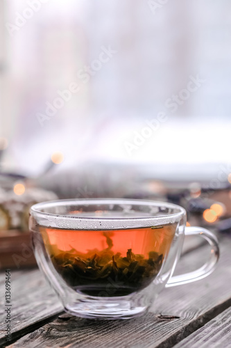Transparent Cup of tea on wooden background