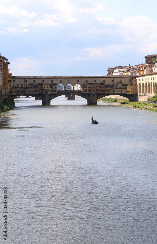 Bridge called Ponte Vecchio in Florence and a boat