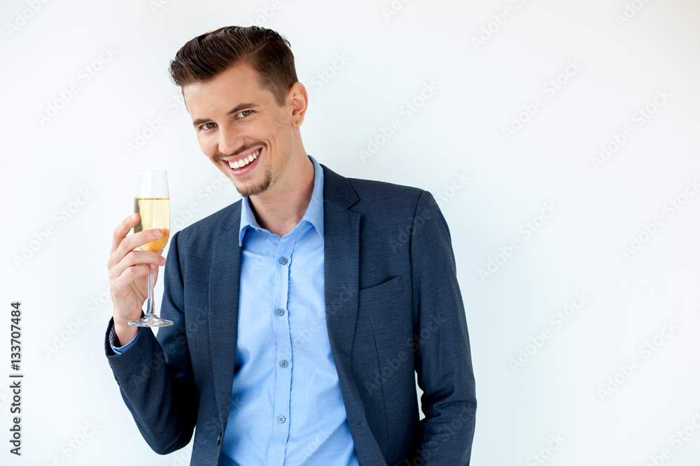 Cheerful young businessman toasting with champagne Cheerful young businessman toasting with champagne