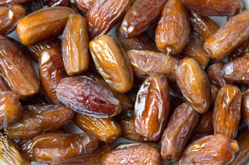 Dry date fruits forming a background