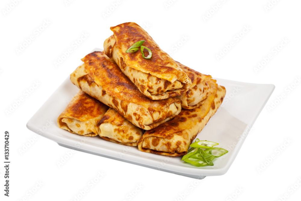 Russian Stuffed Pancakes Blintzes with Meat Isolated on White. Selective focus. Russian Stuffed Pancakes Blintzes with Meat Isolated on White. Selective focus.