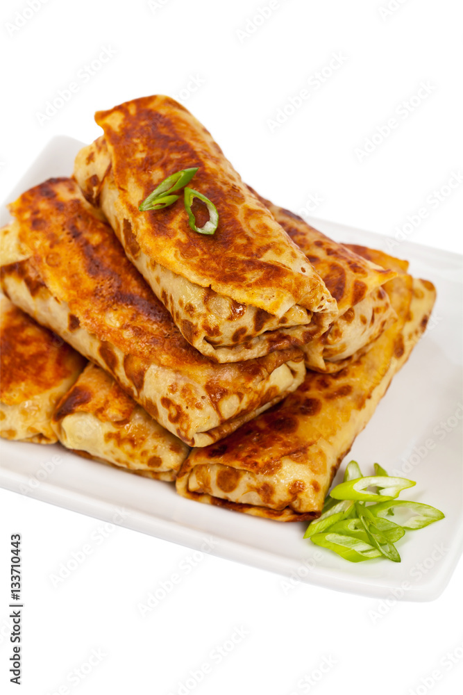 Russian Stuffed Pancakes Blintzes with Meat Isolated on White. Selective focus. Russian Stuffed Pancakes Blintzes with Meat Isolated on White. Selective focus.