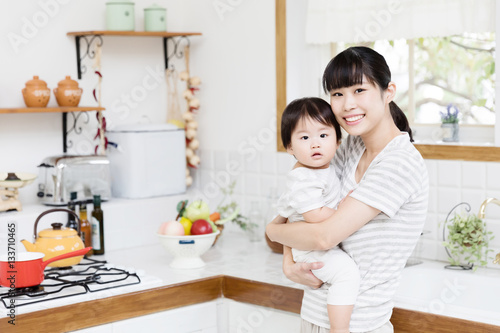 portrait of asian mother and baby in the kitchen