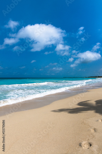 Turquoise waters and gentle waves of a white sand Caribbean beach