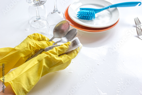 concept of woman washing dishes on white background photo