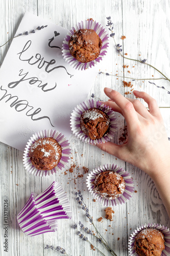 concept of Valentine's Day cupcakes wooden background top view