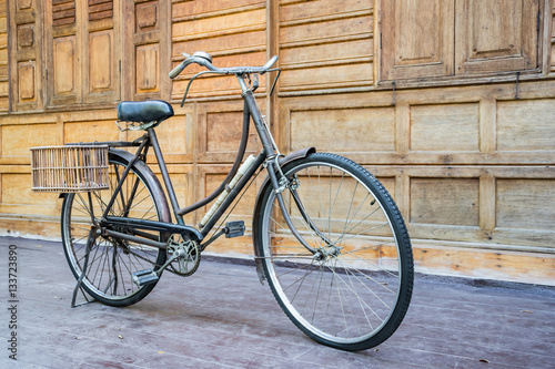 Vintage bcycle standing near wood wall