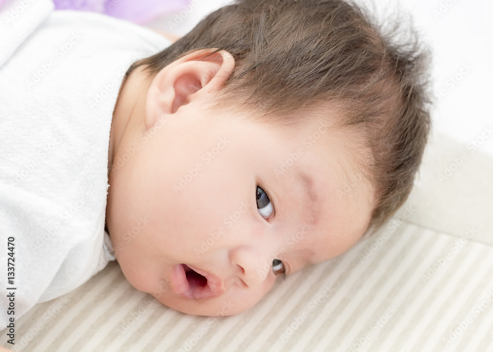 Portrait of adorable baby girl lie on the stomach Portrait of adorable baby girl lie on the stomach