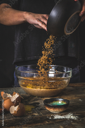 Man pouring brown sugar into bowl
