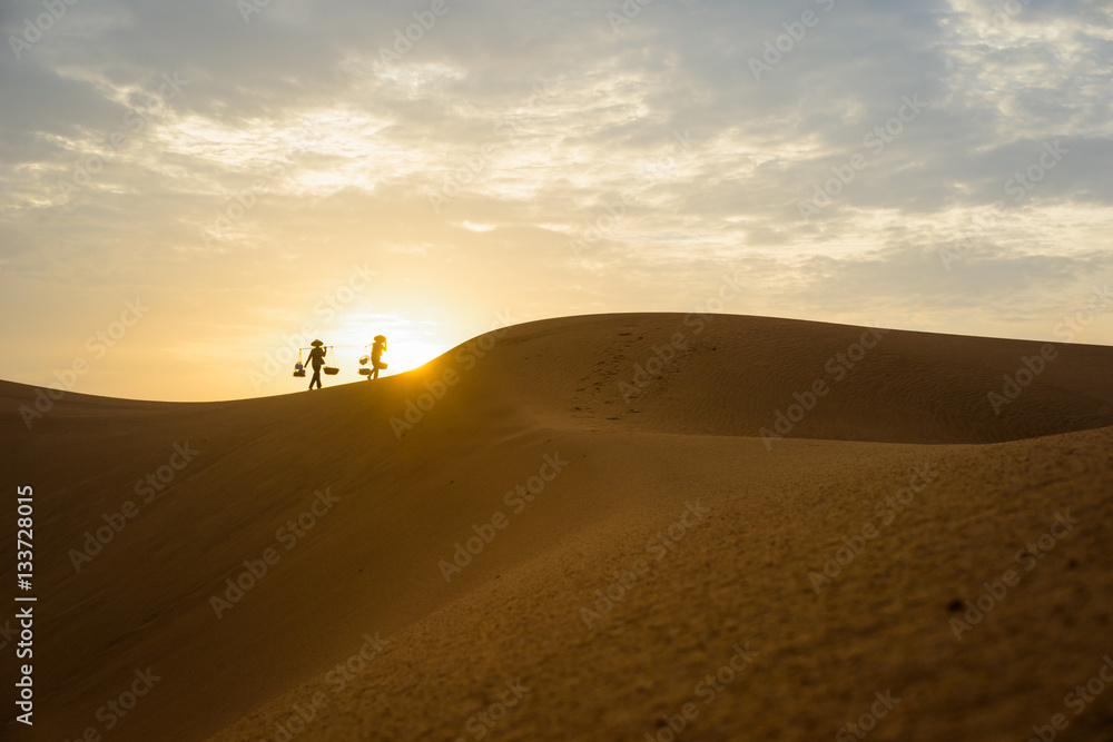 Vietnamese woman vendors on red sand hill in Mui Ne, Binh Thuan