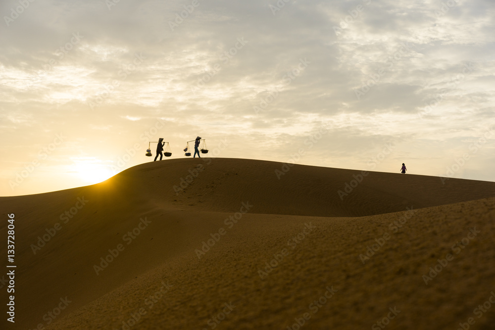 Silhouette of instant food vendors on red sand hill in Mui Ne, Binh Thuan, Vietnam Silhouette of instant food vendors on red sand hill in Mui Ne, Binh Thuan, Vietnam