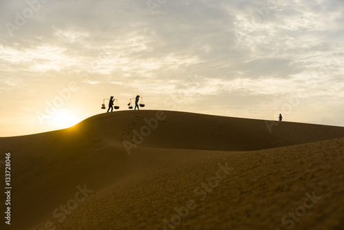 Silhouette of instant food vendors on red sand hill in Mui Ne, Binh Thuan, Vietnam