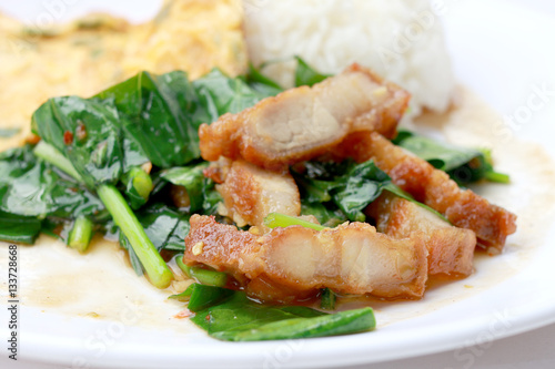 Stir fried kale with crispy pork and Thai Omelette with rice in white dish iIsolated on white background, Thai Food