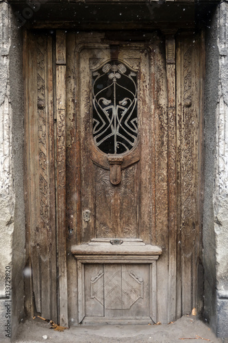 facade of an old building door with forged iron in Tbilisi