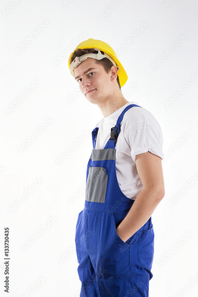 Construction worker standing in a blue suit on a white background Construction worker standing in a blue suit on a white background