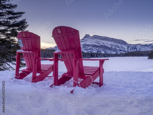 Red Chairs at Two-jack Lake in Banff National Park, Alberta, Canada. Rundle Mountain is in the background. 