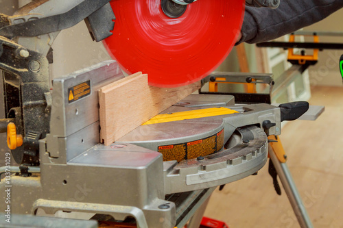 Carpenter workplace Man using circular saw to cut wood