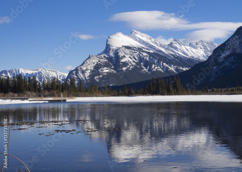 Mount Rundle reflected in the icy waters of Vermillion Lakes near Banff Alberta Canada