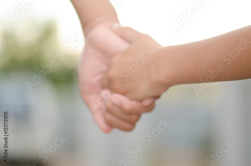 .Two little kids holding hands and holding hands walking. The me