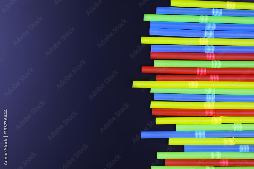 cocktail colorful plastic tube on a black background cocktail colorful plastic tube on a black background