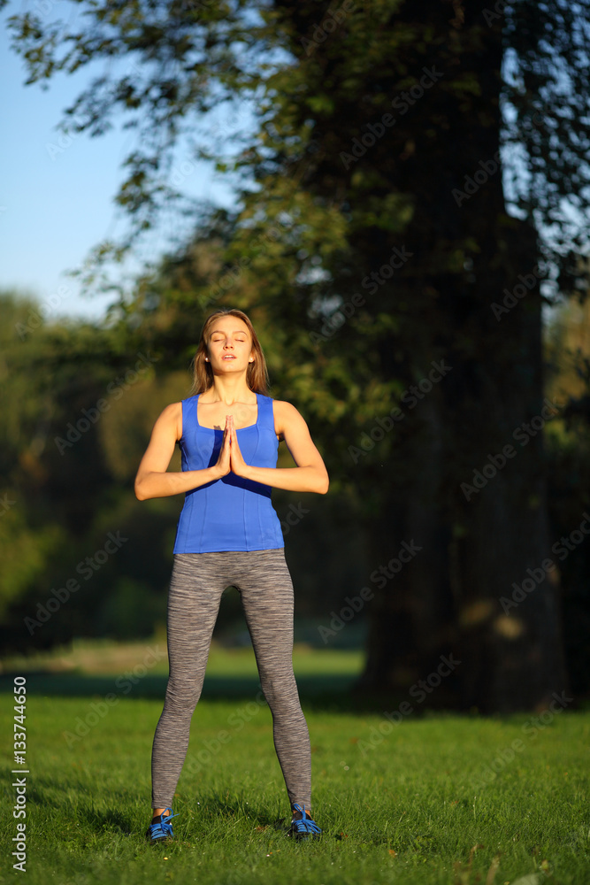 Beautiful woman with praying hands and closed eyes stand Beautiful woman with praying hands and closed eyes stand