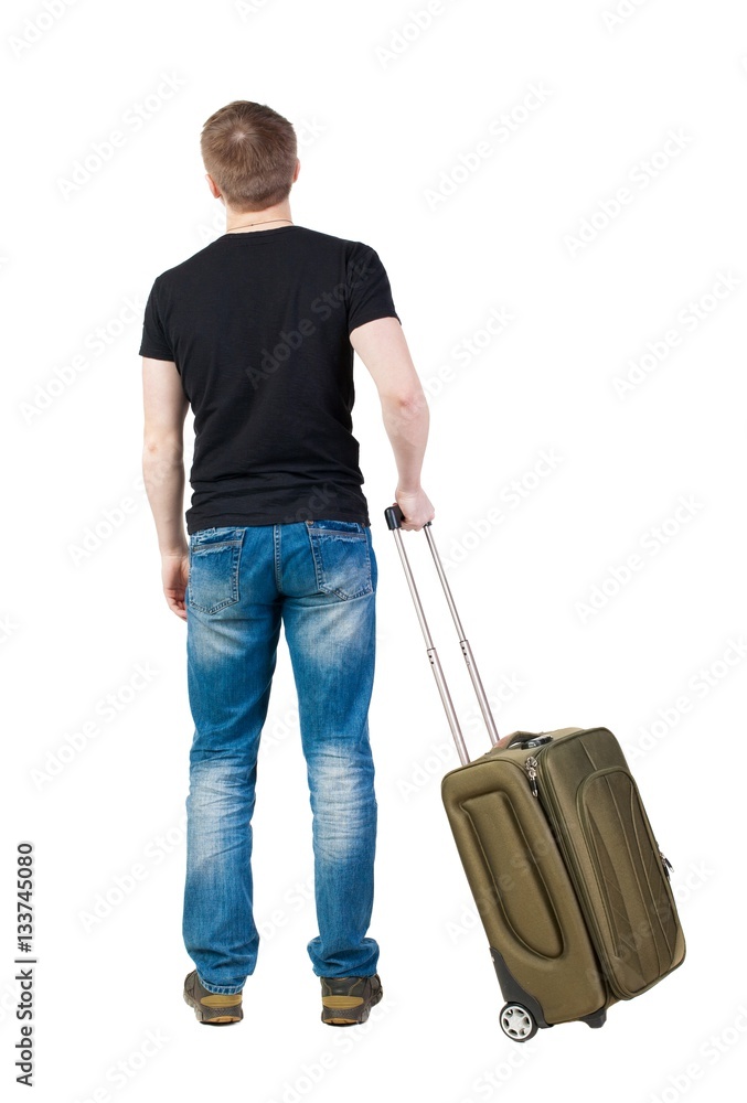 Back view of man with green suitcase looking up. Rear view people collection. backside view of person. Isolated over white background. Tourist holding the handle of a suitcase on wheels. Back view of man with green suitcase looking up. Rear view people collection. backside view of person. Isolated over white background. Tourist holding the handle of a suitcase on wheels.