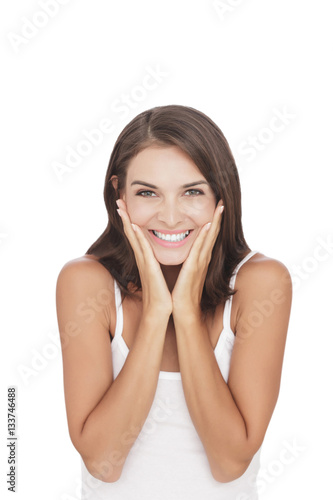 beautiful woman smiling while her hand on her cheek