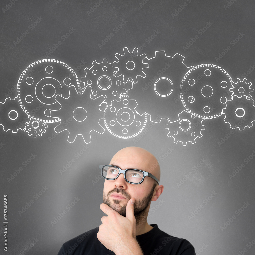 Gear wheel going out of the head of a young attractive smiling m Gear wheel going out of the head of a young attractive smiling m