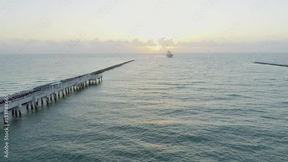 Cargo Ship Entering Government Cut South Miami Beach Waterway at Sunrise Panning Shot Cargo Ship Entering Government Cut South Miami Beach Waterway at Sunrise Panning Shot