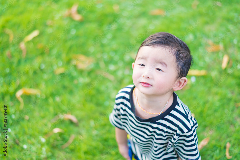 Close-up little Asian boy looking up somewhere and thinking with Close-up little Asian boy looking up somewhere and thinking with