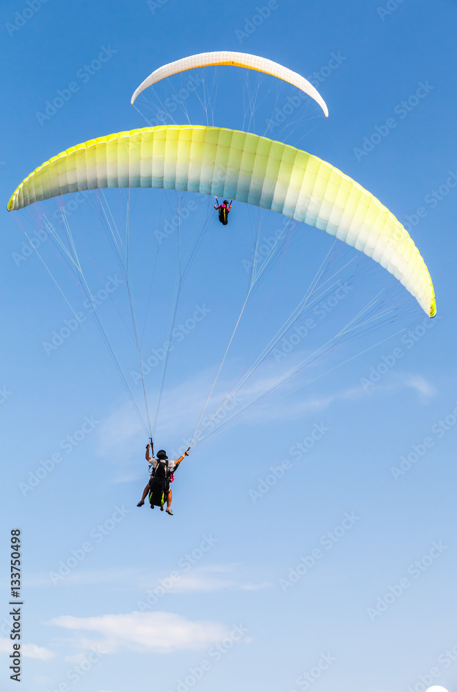 Amateur paragliders in blue sky with clouds Amateur paragliders in blue sky with clouds