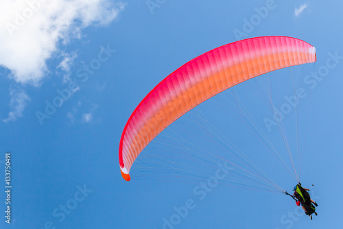 Paragliders in blue sky with clouds, tandem