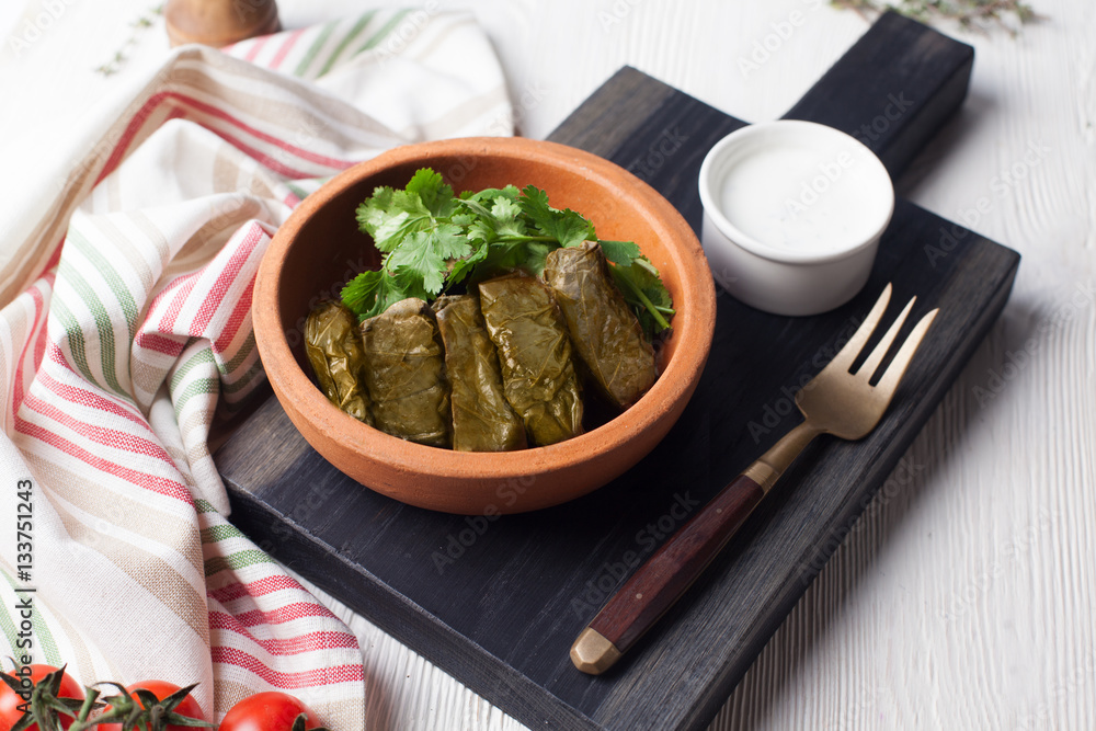 dolma with parsley and sour cream still life in a crock dolma with parsley and sour cream still life in a crock