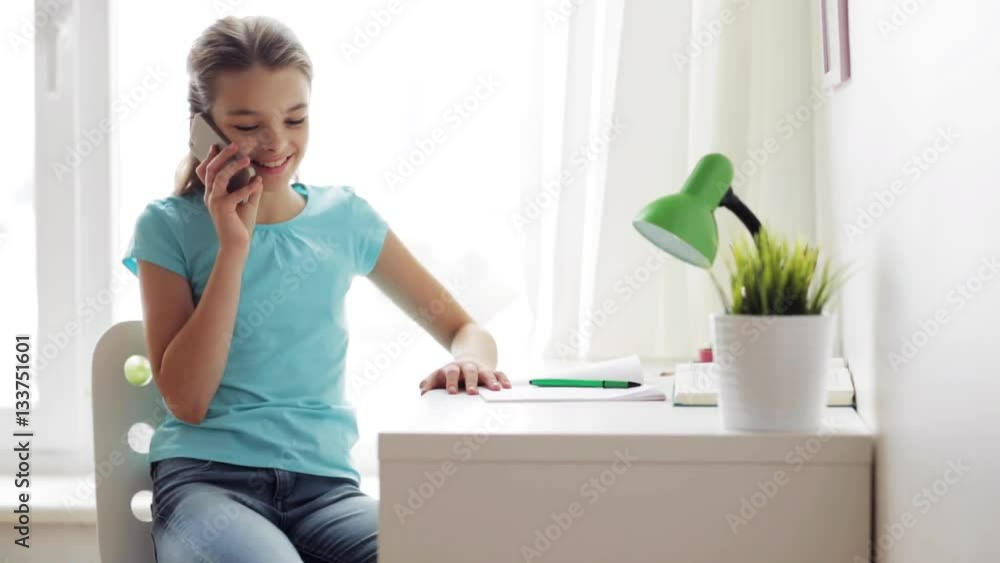 smiling girl calling on smartphone at home