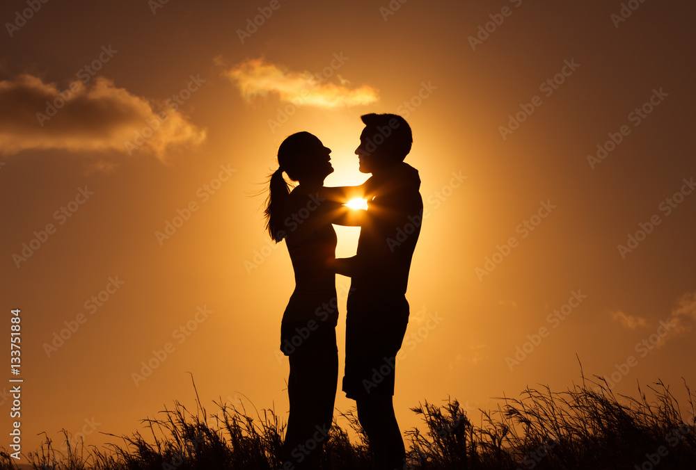 People love, fun and relationships. Young happy couple embracing in the sunset. 