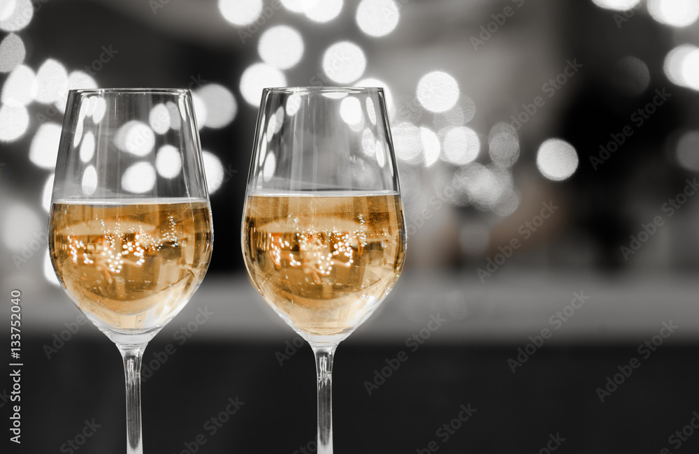 Fototapeta premium Party time! Pair of wine glasses against a sparkling background. 